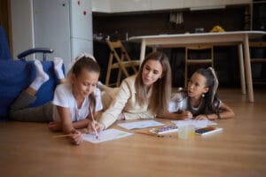 Mother and children doing creative learning activities at home for preschool curriculum