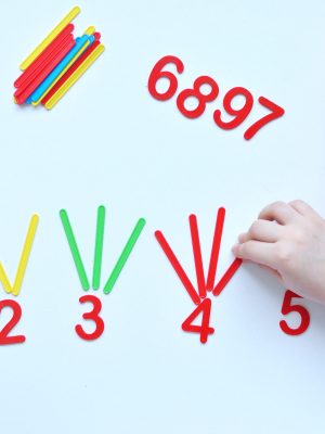 The child learns Number line and geometric shapes. The preschooler works with Montessori material. Educational logic toys for kid's. Children's hands close-up. Montessori Games for Child Development